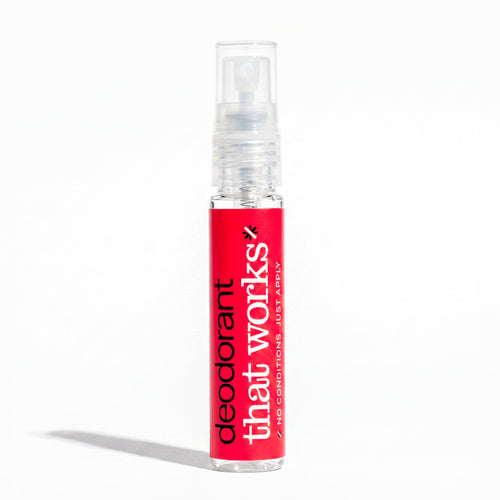 A single small spray bottle of deodorant standing upright on a clean white background. The bottle has a bright red label with vertical white text reading 'deodorant that works' and a clear cap.